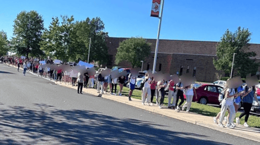 High school students walking outside of a school building