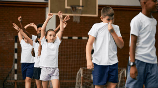 A group of middle school students participating in a PE class